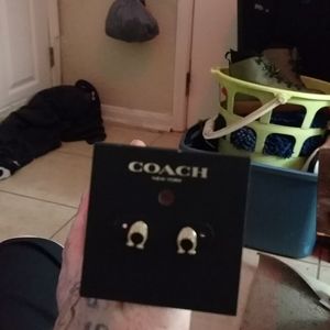 Gold earrings by Coach